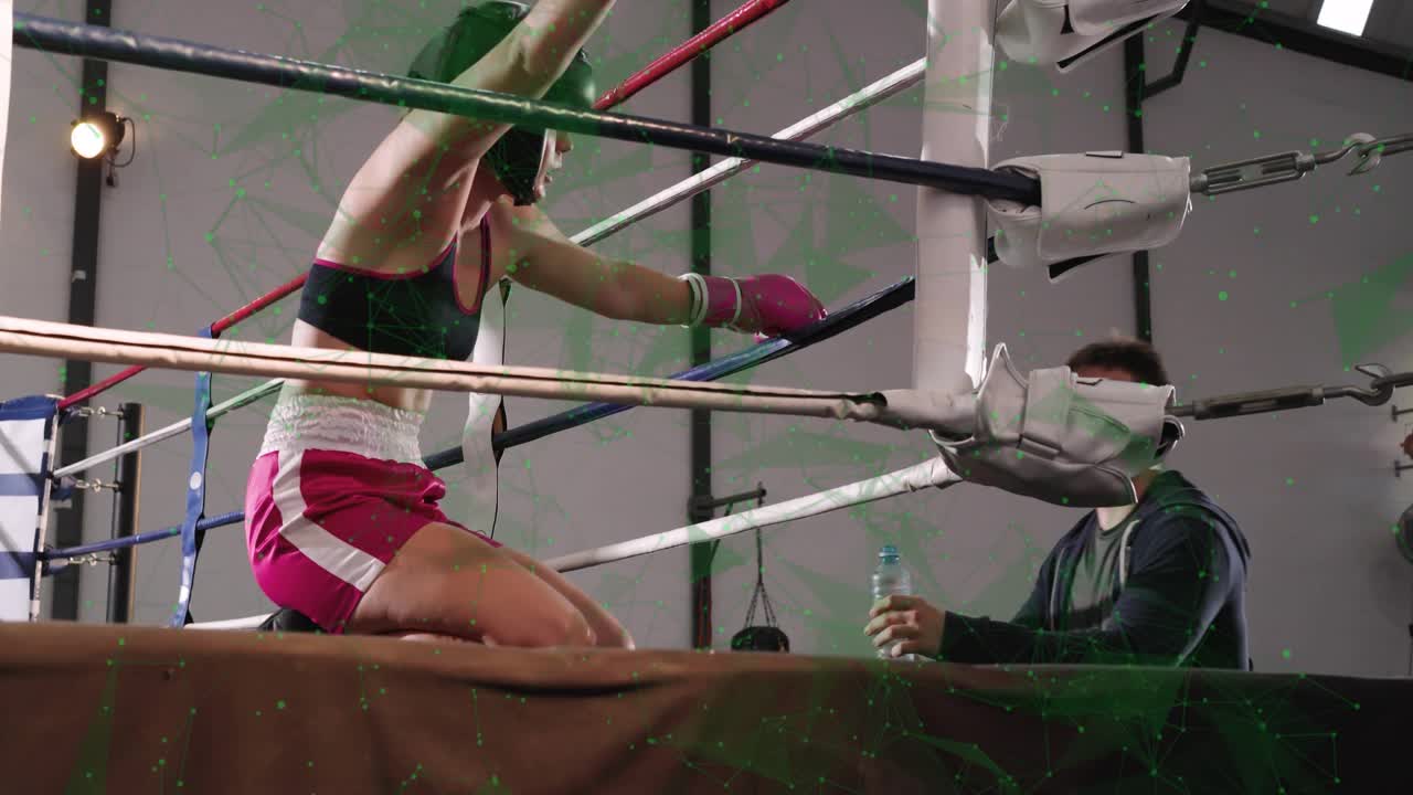 Boxer in pink retreating toward corner in boxing ring after opponent punches, kneeling for water