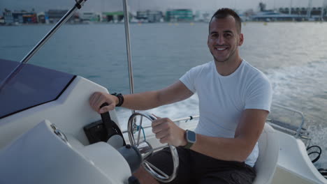 man driving a boat in a marina