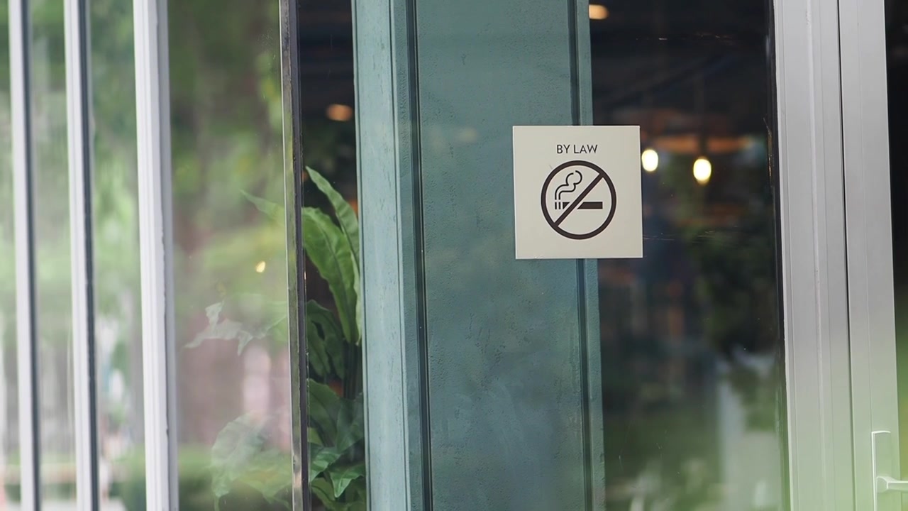 No Smoking Sign on Glass Door of Modern Building