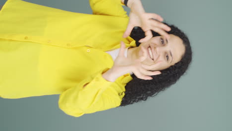 Vertical-video-of-The-young-woman-looking-at-the-camera-says-you-are-amazing.