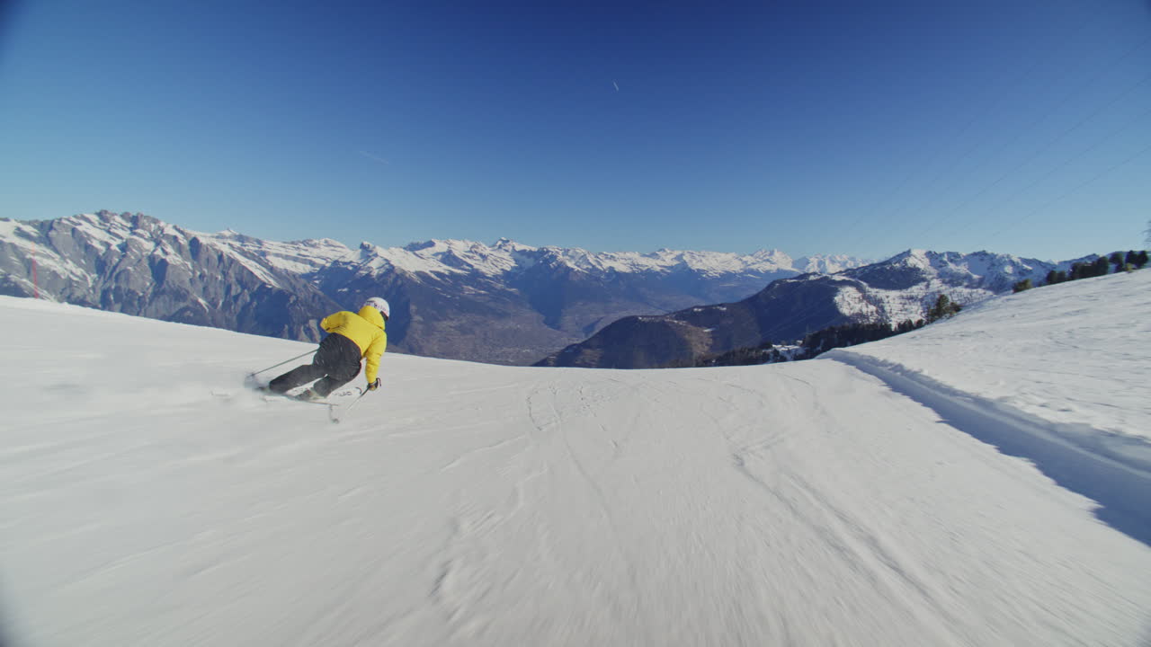 High performance alpine ski carving on groomed pistes in Verbier Bruson and Val de Bagnes filmed with drone and follow cam on a bluebird winter day showcasing fast dynamic fun skiing