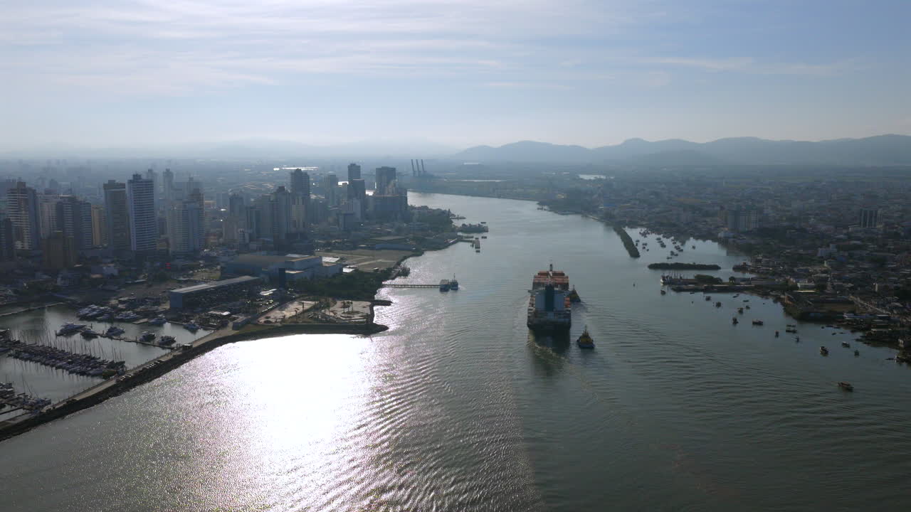Aerial view of city with container ship on river
