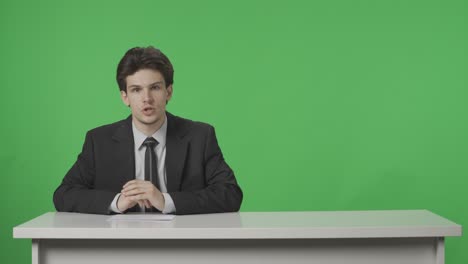news anchor at a desk on a green screen