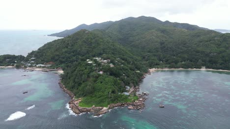 scenic aerial view of la digue island, seychelles archipelago indian ocean with wooden house resort at top of the hill overlooking the sea , vacation paradise destination