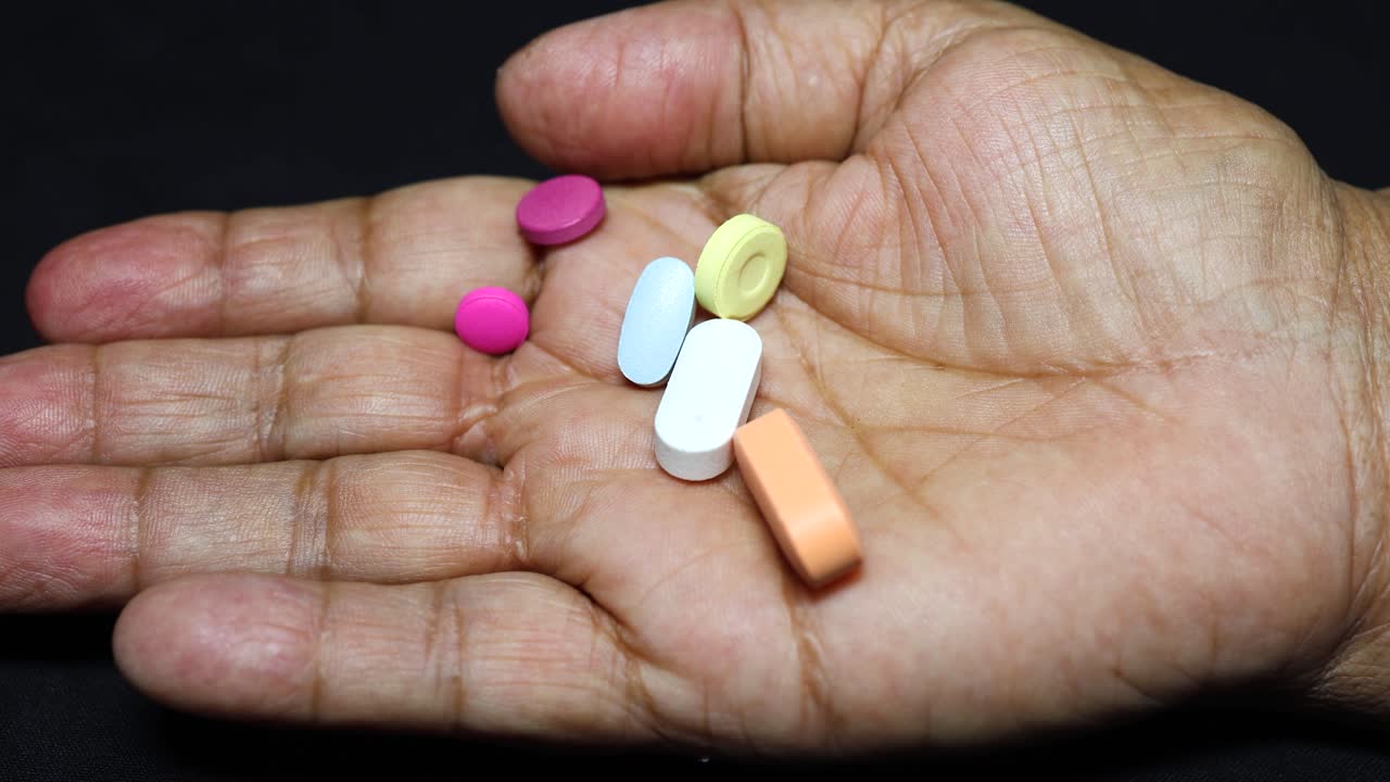 healthcare concept with old hand and tablets indoors