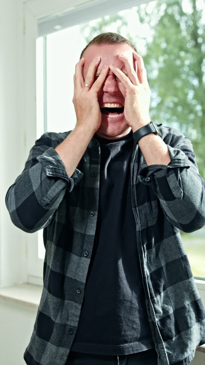Emotional portrait of a man close-up. Male face with a scream and anger emotions. An irritated man looks into the frame