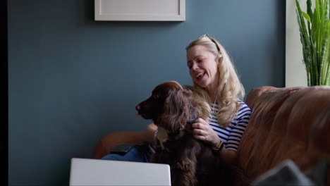 woman showing affection to her dog at home