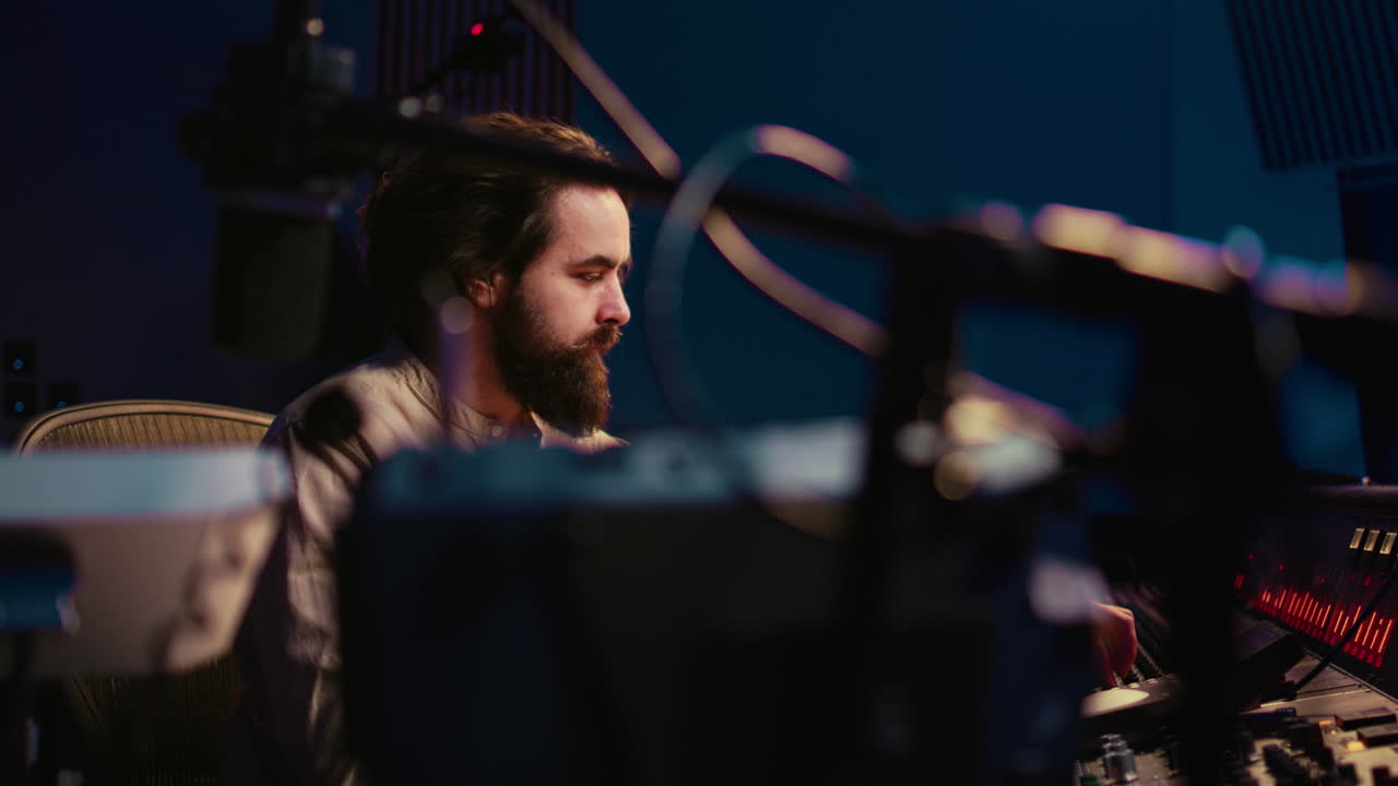 Music engineer working in professional studio control room to do mix and master