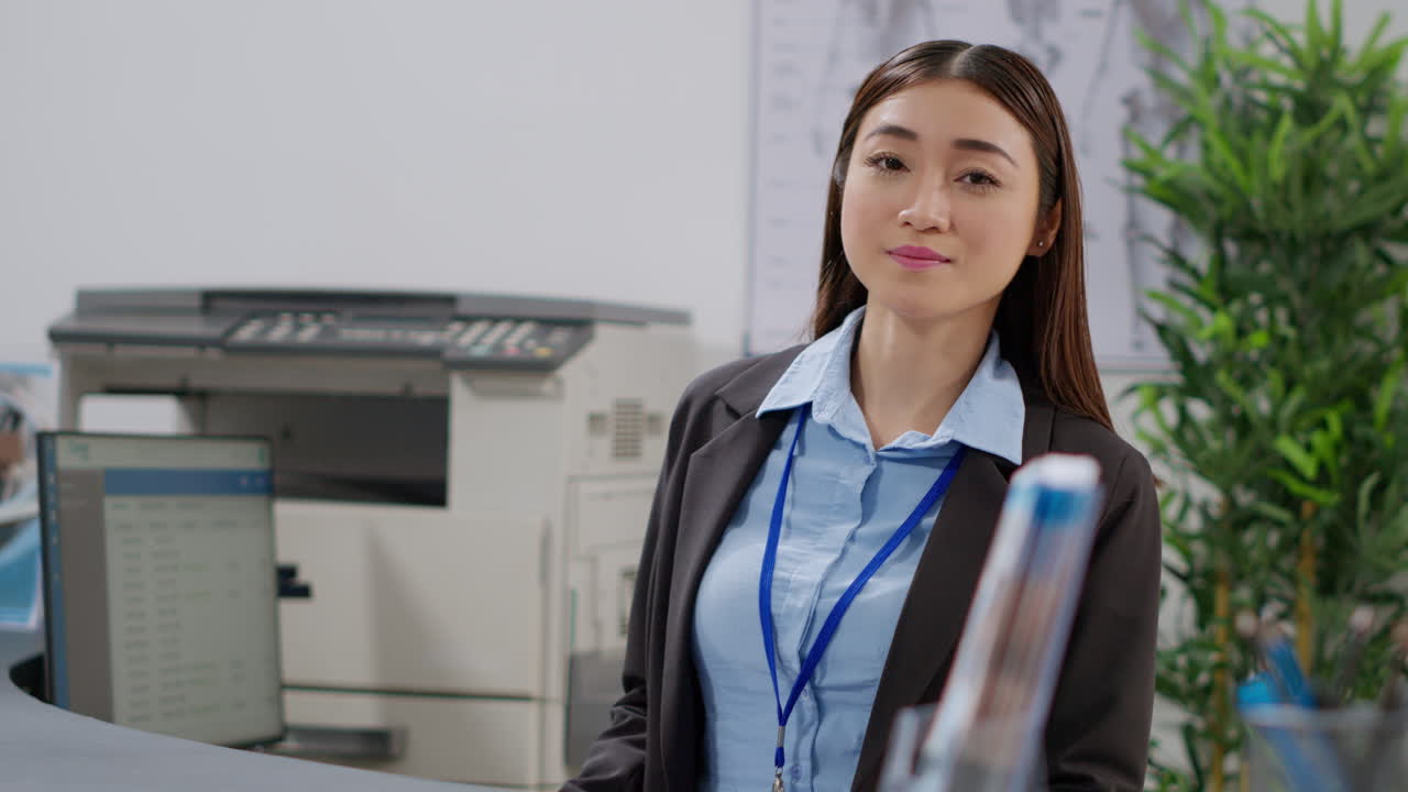 Receptionist working at reception desk