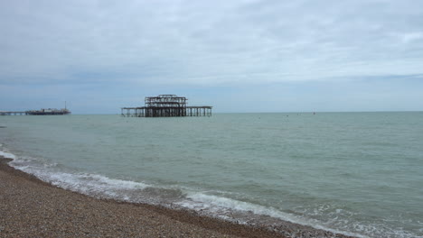 wide shot of the sea on the south coast of england with brighton pier in the background