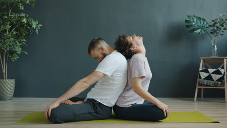 couple practicing backbend yoga pose
