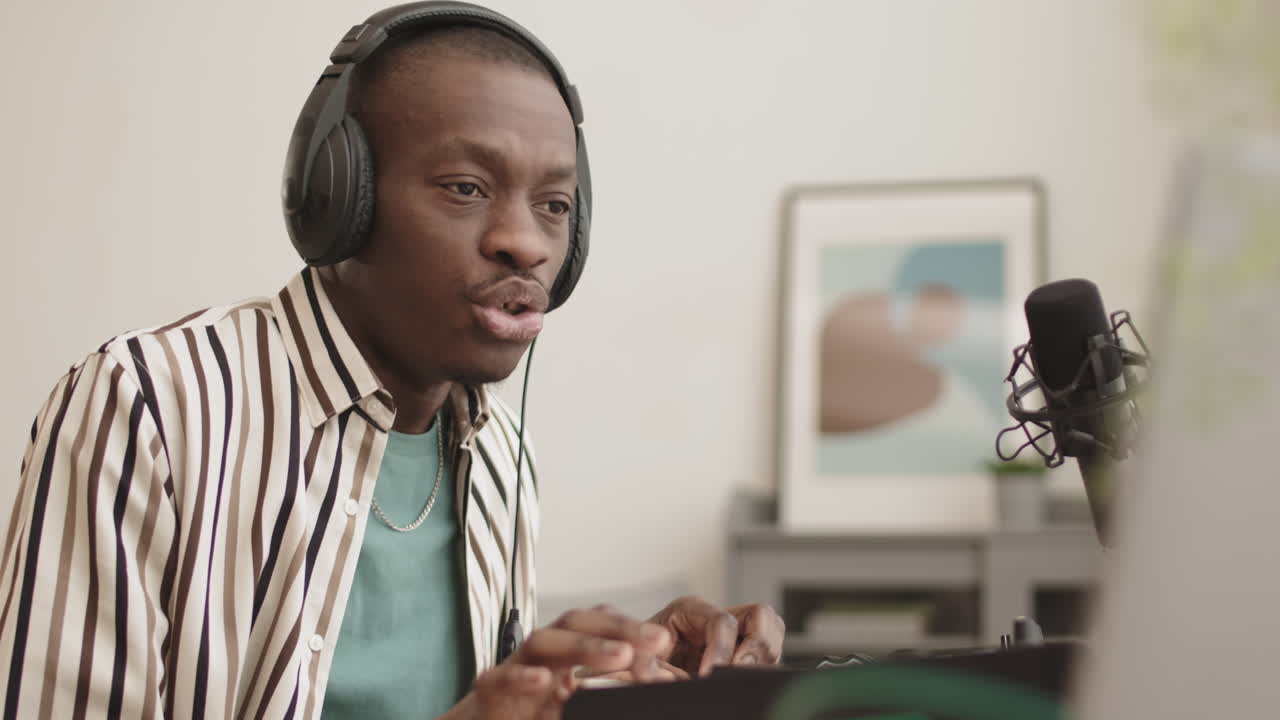 African American Man Making Electronic Music at Home