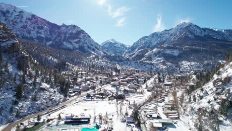 Drone-flying-into-Ouray,-Colorado-from-the-north-side-on-a-sunny-day