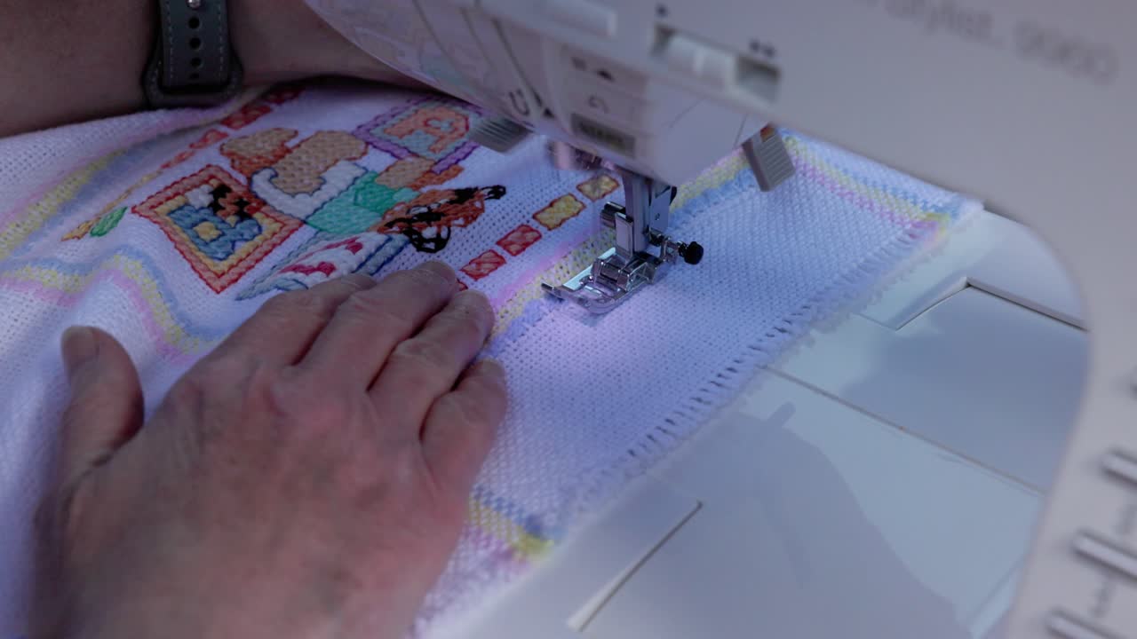 newly made baby blanket being finished on an electric sewing machine