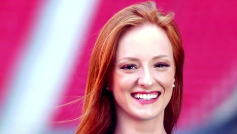 model smiling to the camera in soccer stadium chairs on the backgroud, beautiful shoot in wonderful light