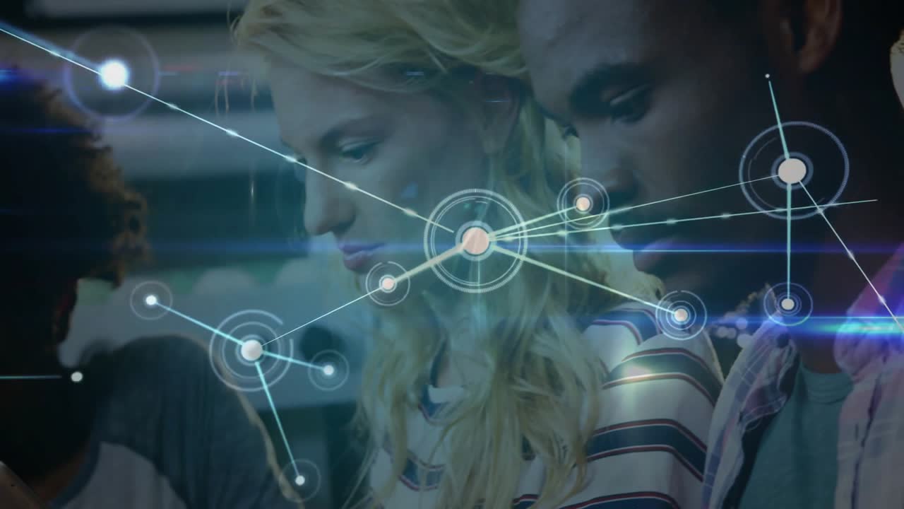 Coworkers tapping phones and swiping tablets, initiating node animation forming business network