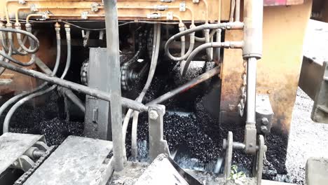 trabajadores de la construcción de carreteras con máquinas pavimentadoras en india, máquinas pavimentadoras de asfalto, primer plano, pavimentadora de asfalto aplicando asfalto en la carretera