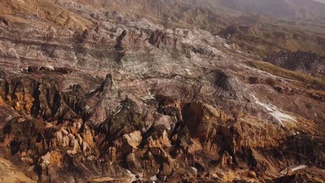 peak clouds fog in desert climate in natural rock cliff nature salt mountain black grey golden color background highland concept of hiking in nature aerial drone shot scenic amazing martial landscape