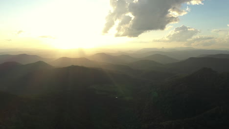 Panning-aerial-shot-of-mountain-landscape-during-sunset-at-Border-Ranges-National-Park,-New-South-Wales-in-Australia