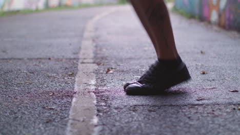 Close-Up-Shot-of-Young-Athletic-Man's-Shoes-Whilst-He's-Jumping-Rope---Skipping-in-an-Underpass