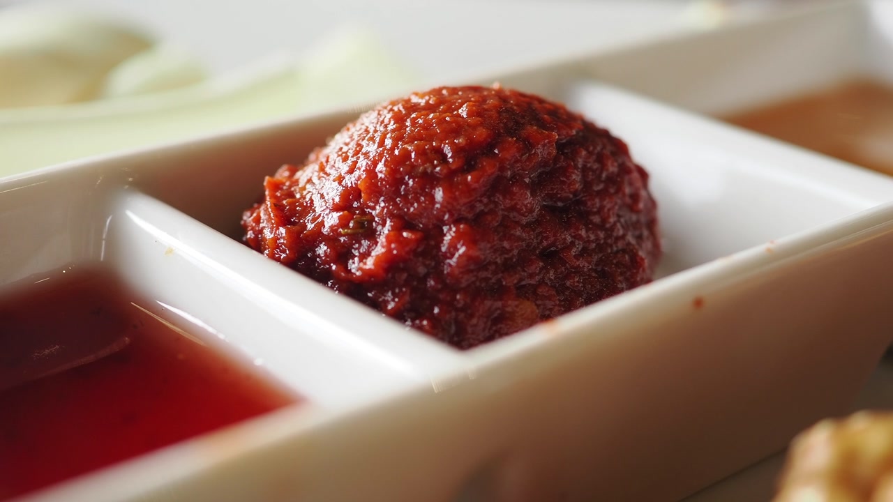 Vibrant Red Chili Paste and Sauces in a White Serving Dish