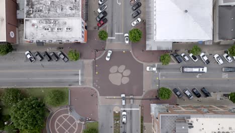 Overhead-view-of-tiger-paw-print-on-intersection-in-Auburn,-Alabama-with-drone-moving-down