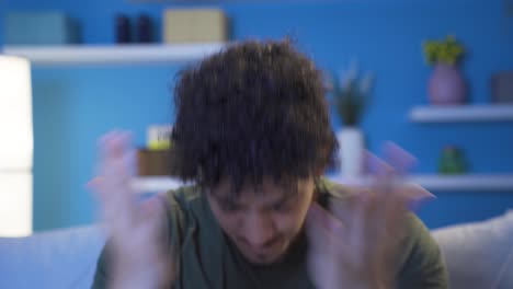 Close-up-portrait-of-aggressive-young-man-at-night-at-home.