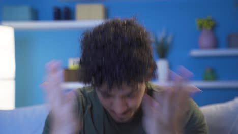 집에서 밤에 공격적인 젊은이의 클로즈업 초상화.