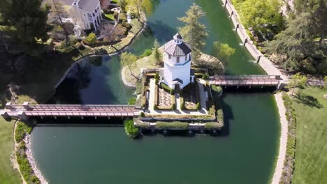 Bridgeport-park-lighthouse-building-on-water-in-Valencia,-California,-4K-aerial