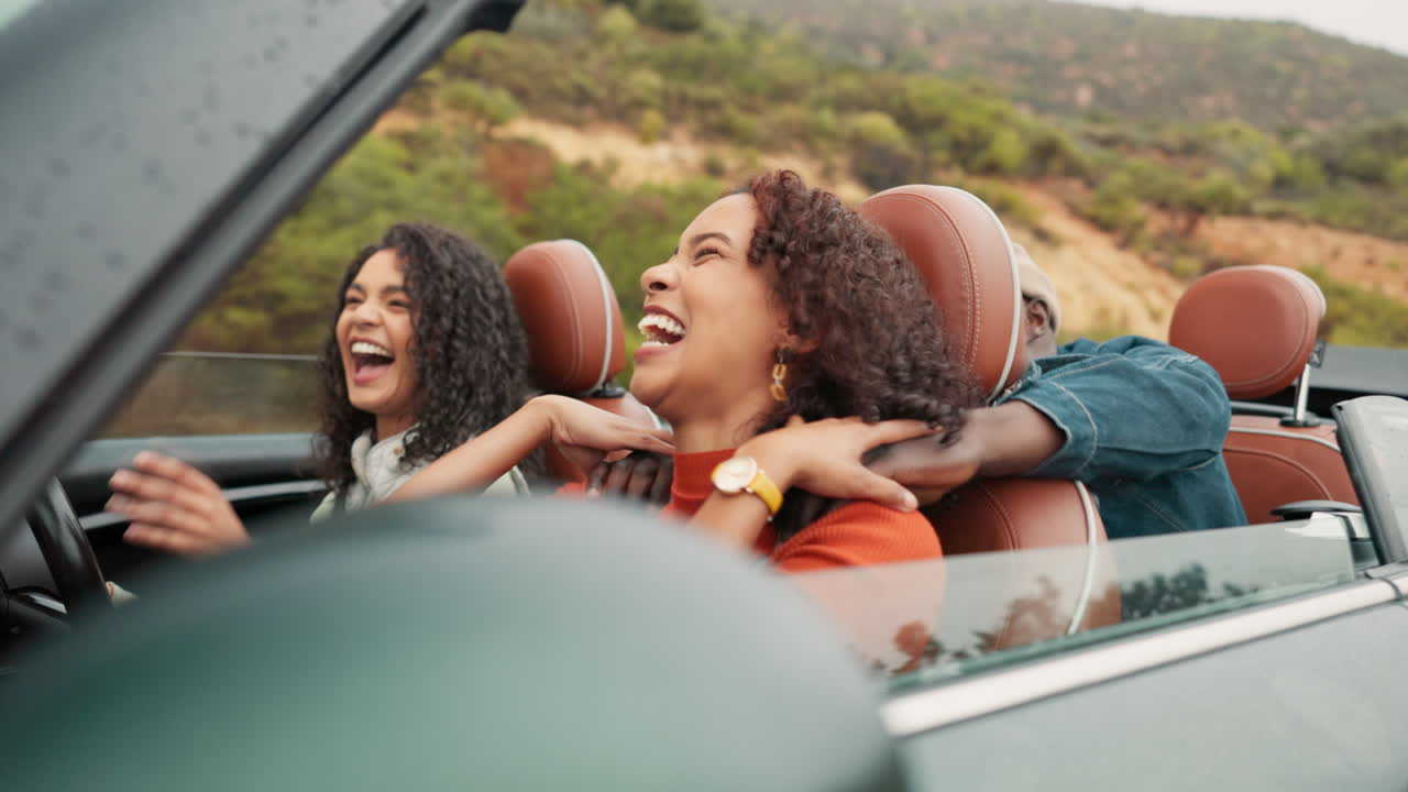 Friends enjoying a fun road trip in a convertible