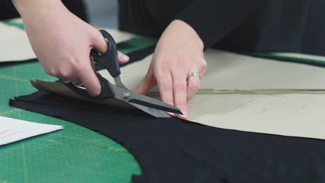 A-woman-cutting-the-fabric-for-a-dress