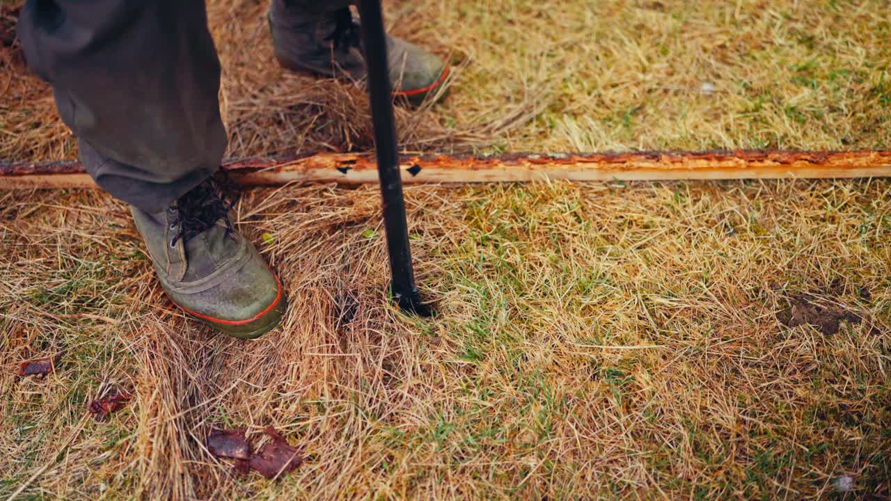 Making Hole For Wooden Post Of The Fence - Close Up