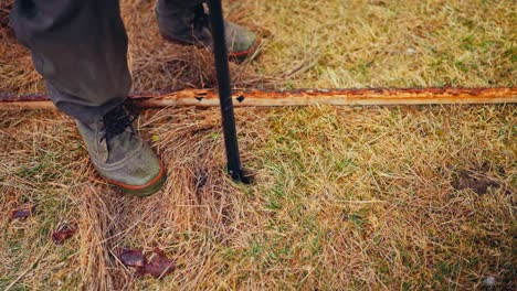 making hole for wooden post of the fence - close up