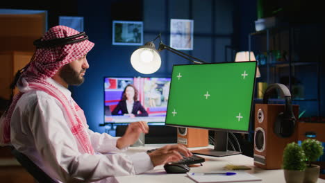 man looks at chroma key computer screen