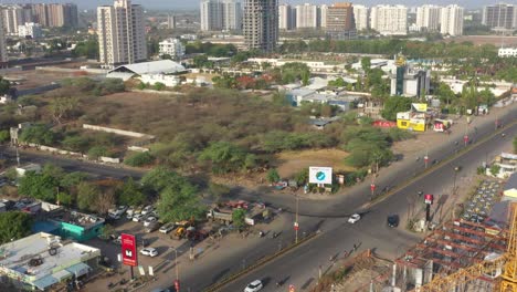 Aerial view of a bustling urban street with ongoing construction and modern buildings