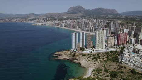 city skyline on mediterranean coastline of benidorm, spain - aerial drone view