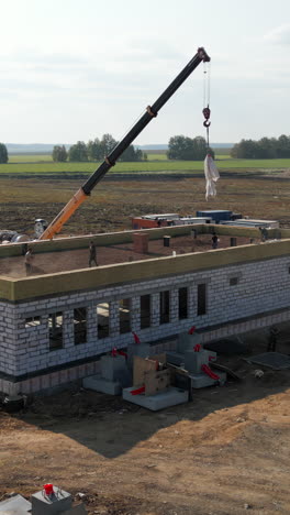 construction site with workers and a crane building a new structure