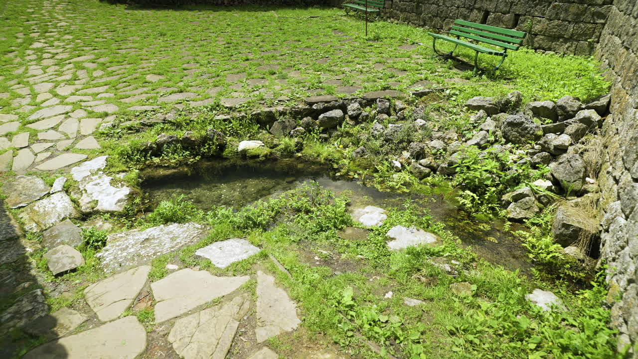 Panning from the right to the left showing a natural spring believed to be miraculous by the followers of Demir Baba Teke, an Alevi saint in Bulgaria.