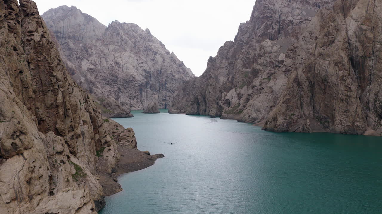 Towering Steep Cliffs At Kel-Suu Lake In The Naryn Region In Southern Kyrgyzstan. Aerial Drone Shot