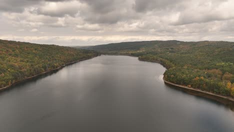 Aerial View of a Serene Lake Surrounded by Autumn Foliage