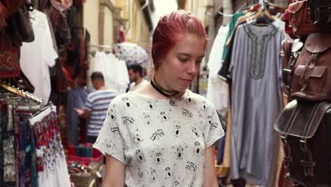 redhead young girl walking through a arabic market