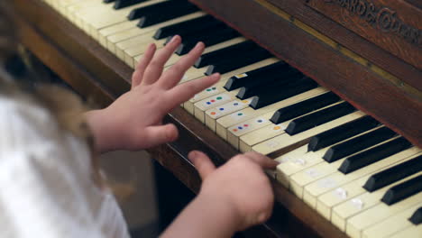 a young girl is learning to play the piano