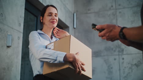 woman happily receives package from delivery person