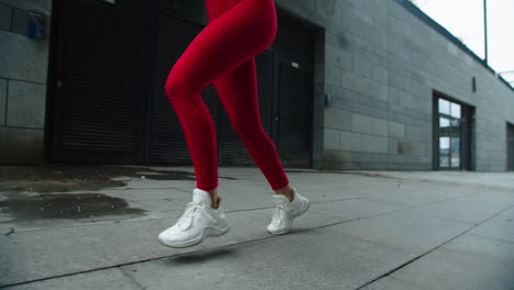 girl legs running outdoor in slow motion. close up female legs running on street