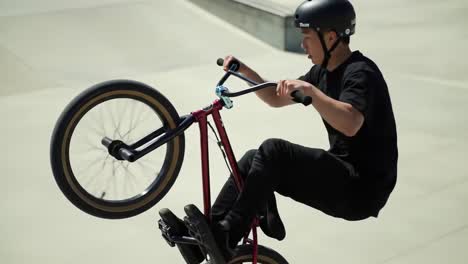 bmx rider performing tricks in skatepark