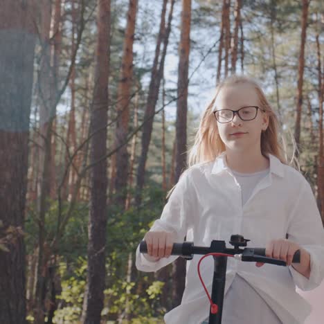 a child rides a scooter amongst tall trees