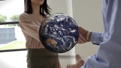 animation of globe over businessman handshake