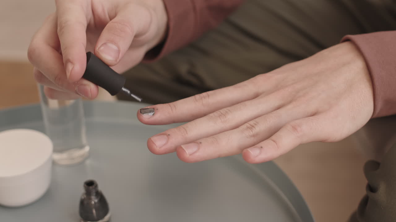 Unrecognizable Young Man Applying Nail Polish