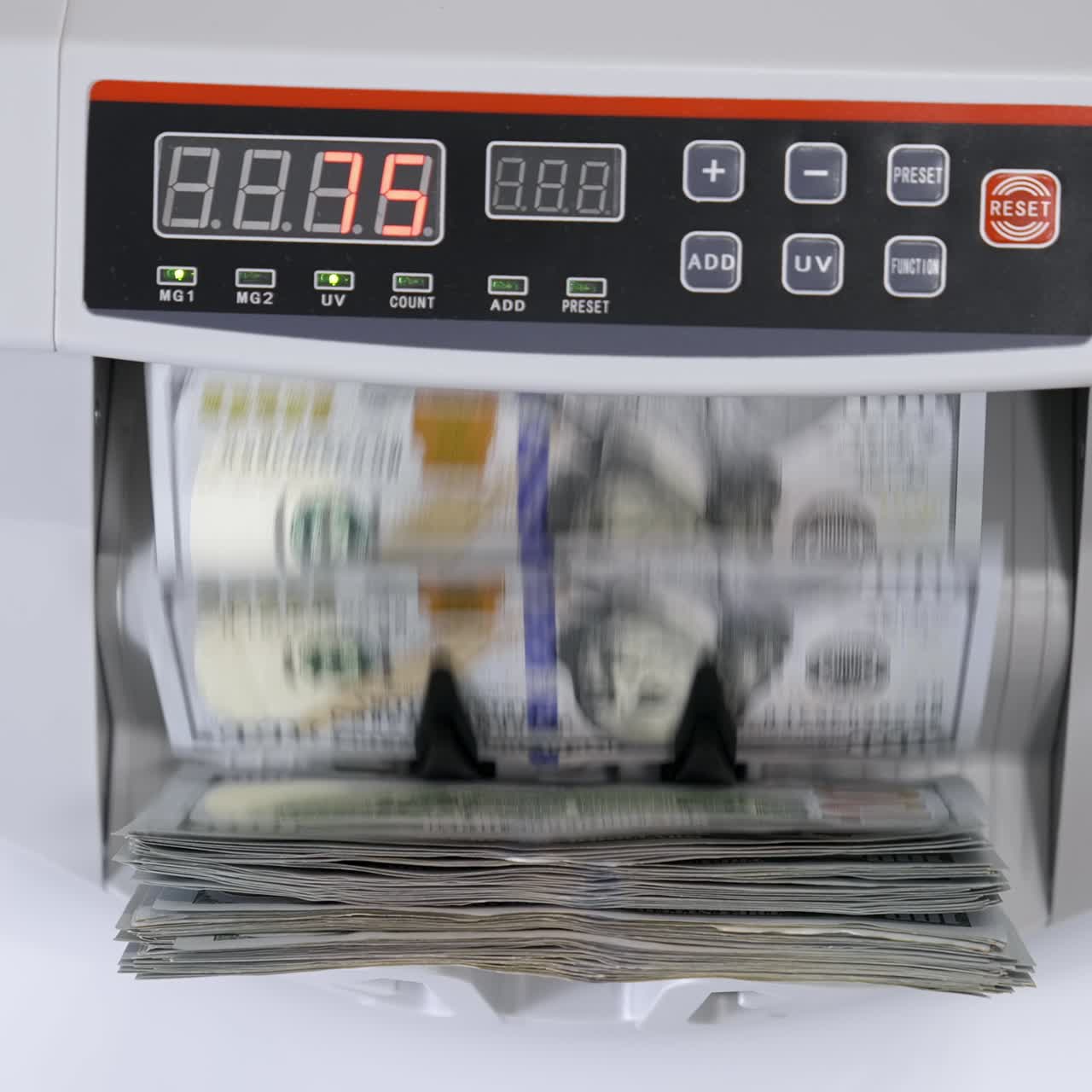 Money counting machine with 100 dollar banknotes. US national paper currency. Bank automatic equipment for calculation paper currency, finance concept