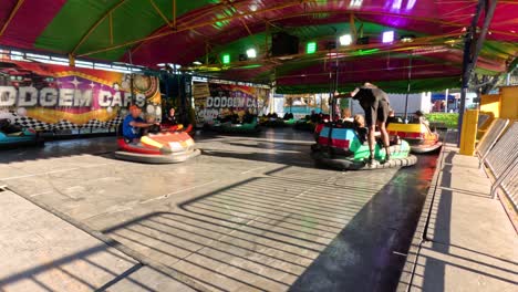 people enjoying bumper cars at a fun fair